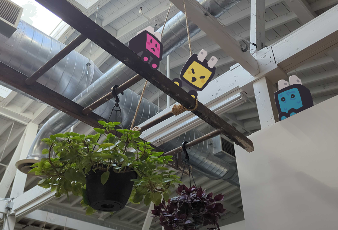 Three adaptor-shaped robots playing on a ladder inside a building